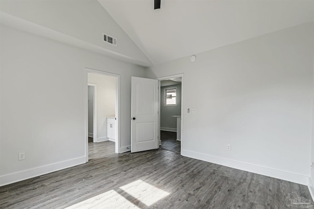 214 Thayer Ave, Pensacola, FL 32507 - empty room with wood finished floors, high vaulted ceiling, baseboards, and visible vents