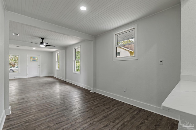 214 Thayer Ave, Pensacola, FL 32507 - unfurnished living room with dark wood-type flooring, baseboards, and a wealth of natural light