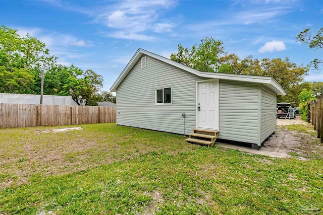 214 Thayer Ave, Pensacola, FL 32507 - rear view of property featuring entry steps, fence private yard, and a lawn