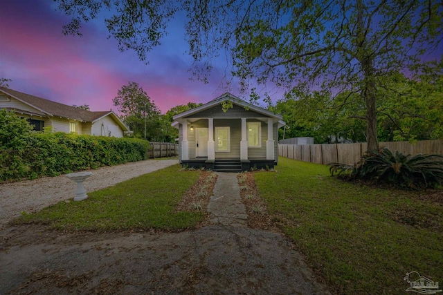 214 Thayer Ave, Pensacola, FL 32507 - view of front of property featuring a yard, fence, covered porch, and driveway