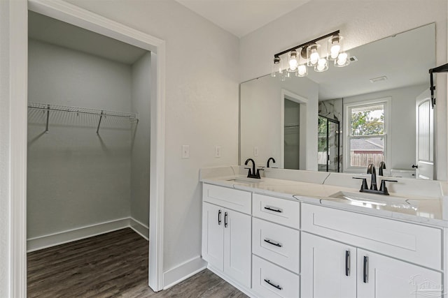 214 Thayer Ave, Pensacola, FL 32507 - full bathroom with a spacious closet, a sink, and wood finished floors