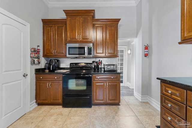 kitchen with tasteful backsplash, light tile patterned floors, crown molding, black electric range, and dark stone counters