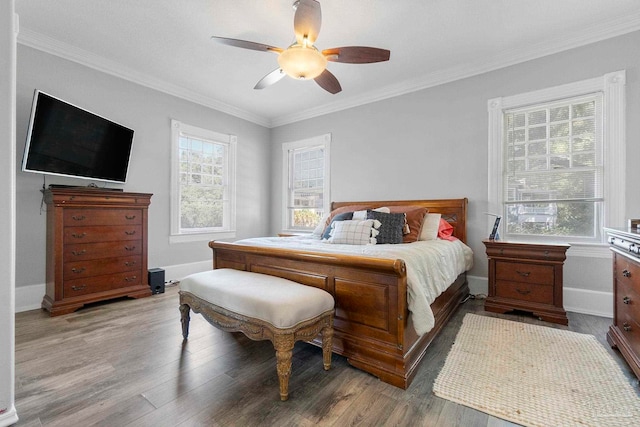 bedroom featuring ceiling fan, hardwood / wood-style floors, and crown molding