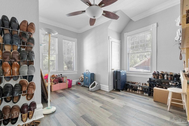 recreation room with ornamental molding, light hardwood / wood-style floors, and ceiling fan