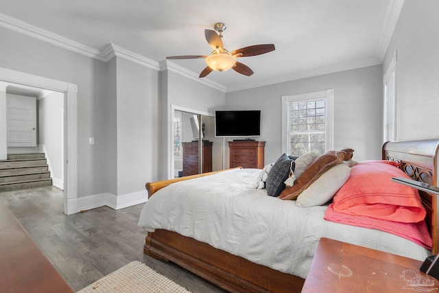 bedroom with ornamental molding, ceiling fan, and dark hardwood / wood-style floors