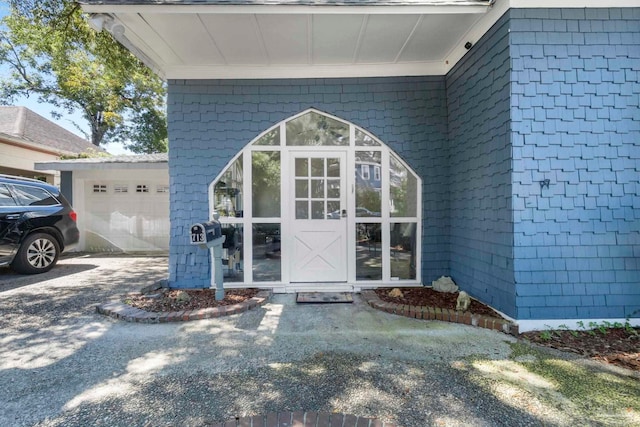 view of exterior entry with a garage