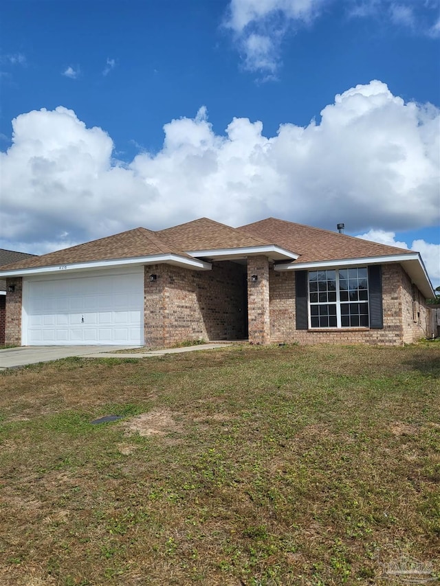 single story home featuring a front lawn and a garage