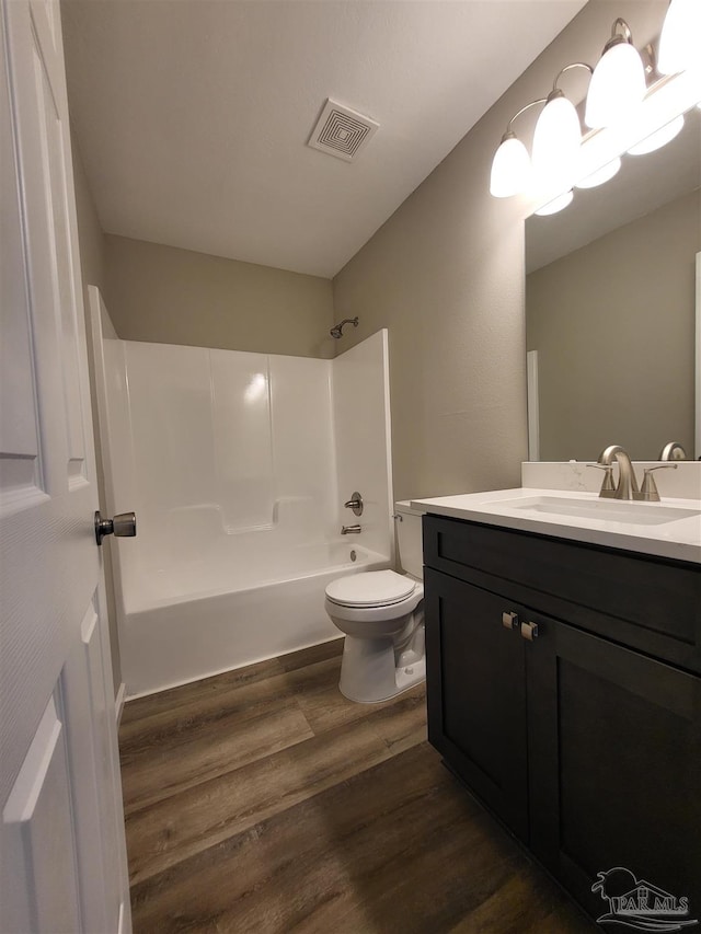 full bathroom featuring vanity, toilet, shower / bathing tub combination, and hardwood / wood-style floors