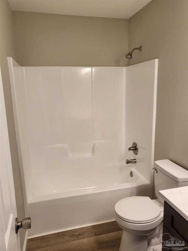 full bathroom with vanity, shower / washtub combination, hardwood / wood-style floors, and toilet