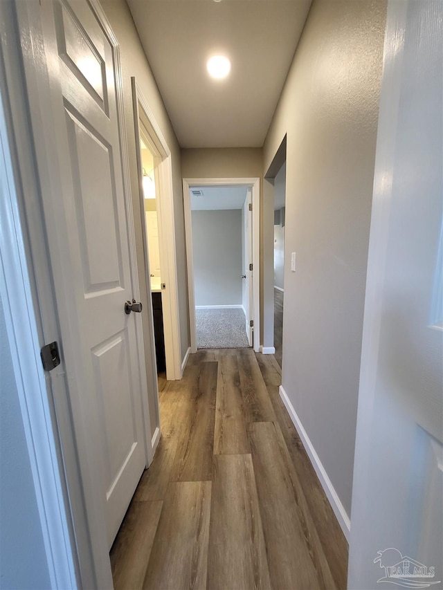 corridor featuring hardwood / wood-style flooring