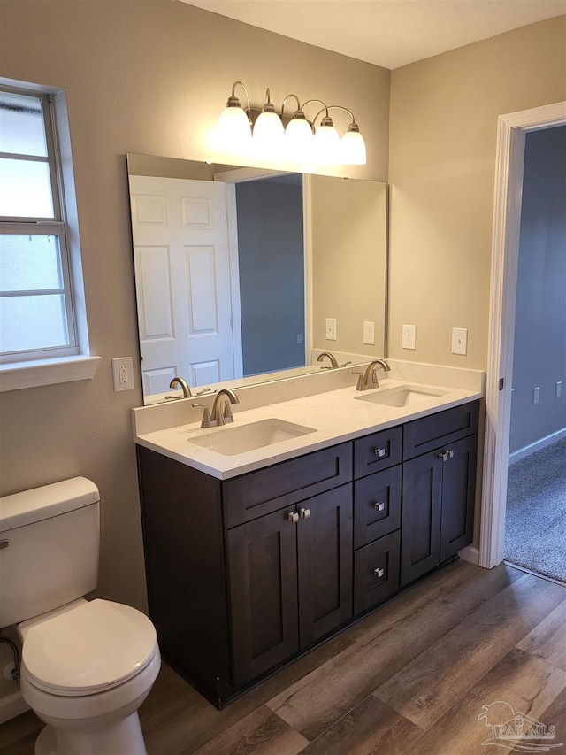 bathroom with vanity, hardwood / wood-style floors, and toilet