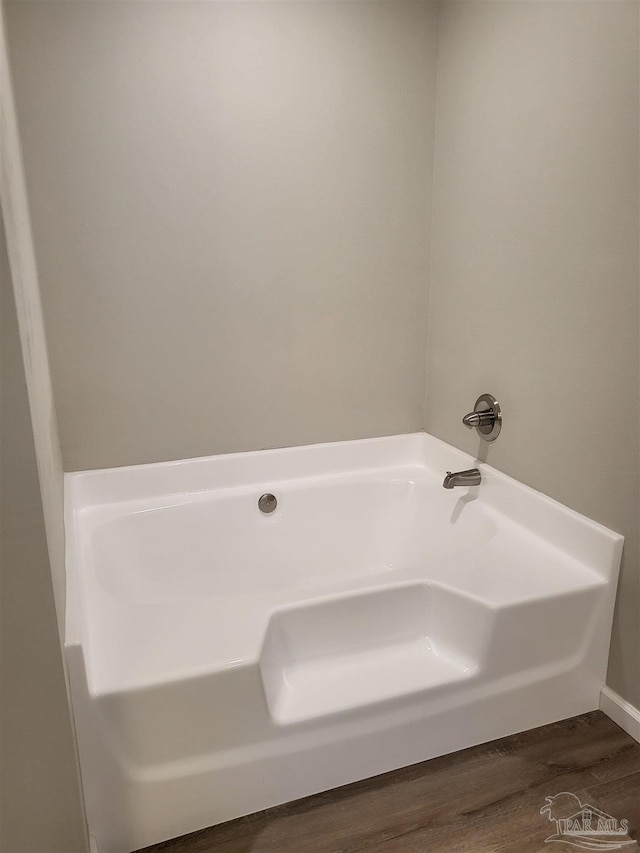 bathroom featuring a bathing tub and hardwood / wood-style flooring