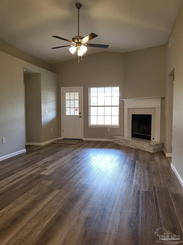 unfurnished living room featuring ceiling fan and dark hardwood / wood-style flooring