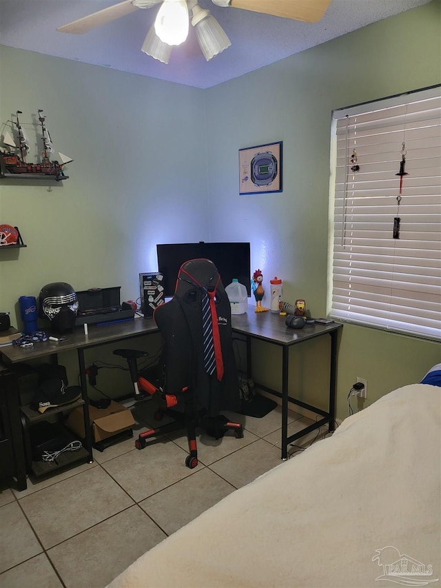 home office with light tile patterned floors and ceiling fan