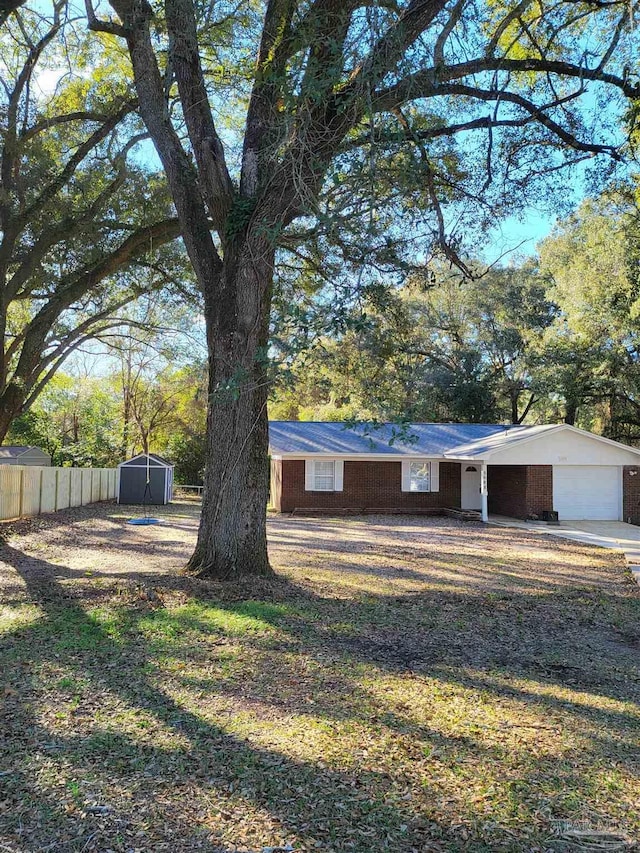 exterior space with a storage shed and a garage