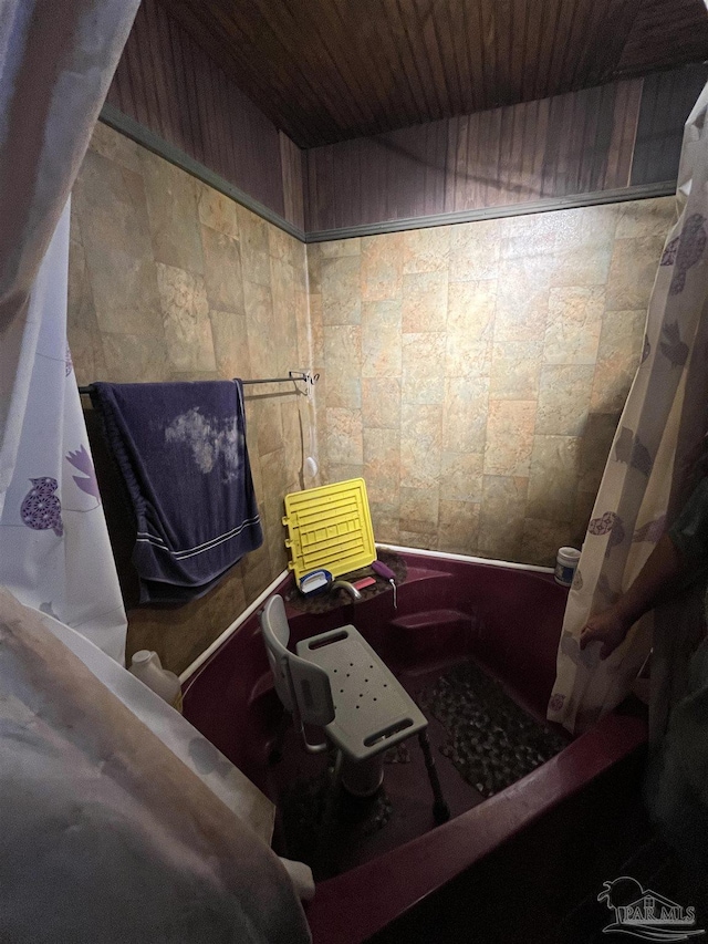bathroom featuring a shower with curtain and wood ceiling