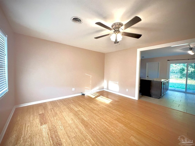 spare room with ceiling fan and light hardwood / wood-style flooring