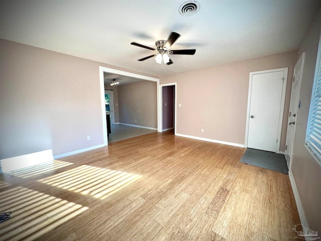 empty room with light hardwood / wood-style floors and ceiling fan