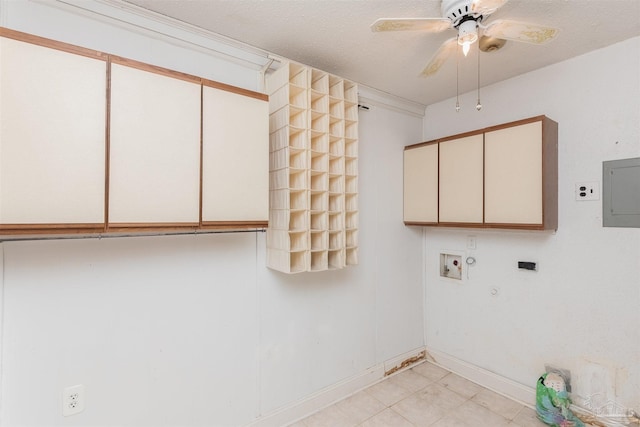 laundry room featuring gas dryer hookup, ceiling fan, electric dryer hookup, electric panel, and cabinets