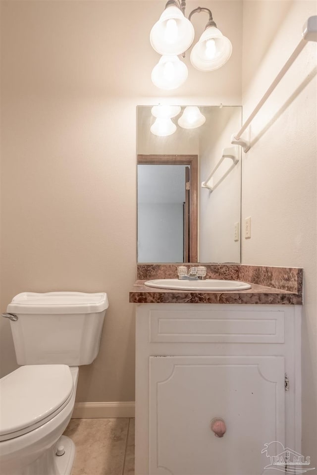 bathroom featuring tile patterned floors, vanity, and toilet