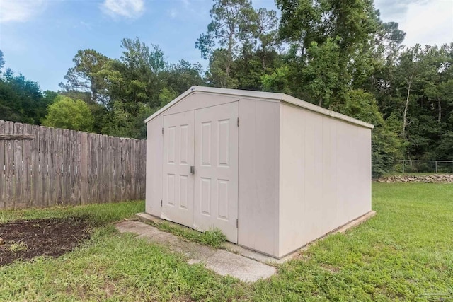 view of outbuilding with a lawn