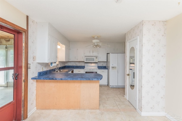 kitchen with sink, white appliances, ceiling fan, light tile patterned flooring, and kitchen peninsula