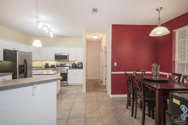 kitchen featuring light tile patterned floors, white dishwasher, white cabinets, and sink