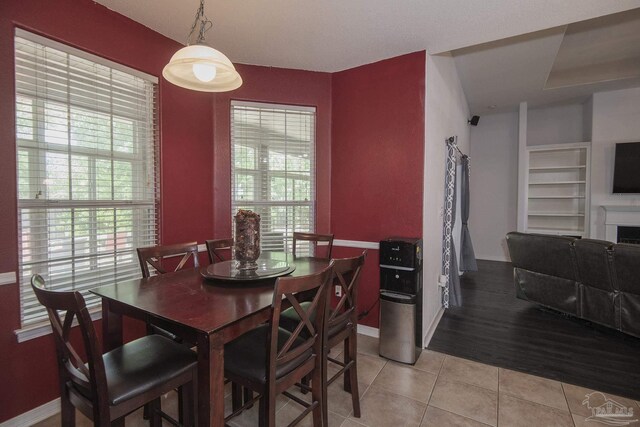 kitchen featuring light tile patterned floors, white cabinetry, dishwasher, and sink