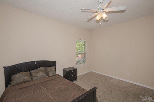 carpeted bedroom featuring a closet and ceiling fan