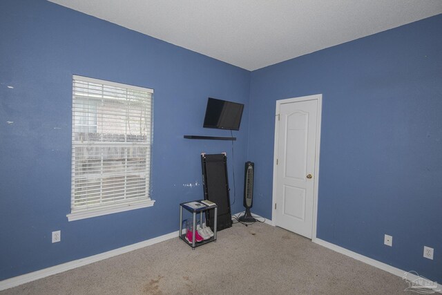 unfurnished bedroom featuring a closet, light colored carpet, and ceiling fan