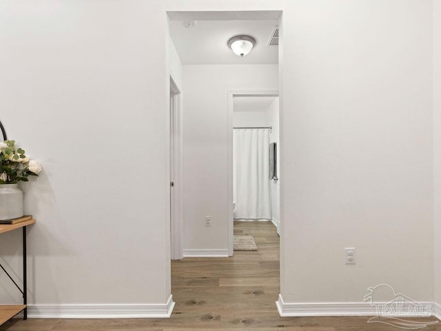 hall with light hardwood / wood-style floors