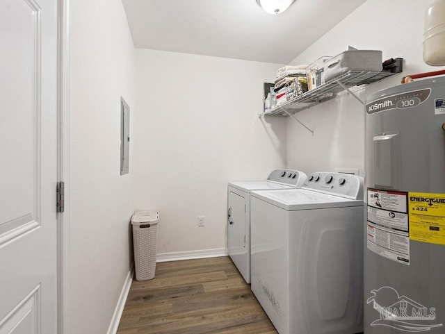 laundry area with washing machine and clothes dryer, electric panel, hardwood / wood-style flooring, and electric water heater