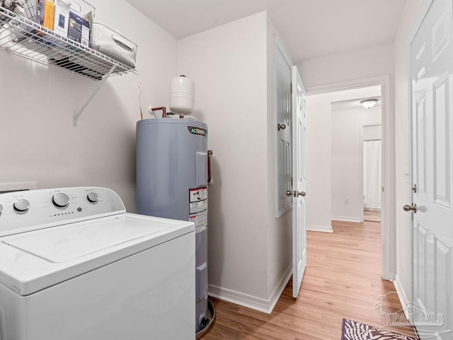 laundry area featuring washer / clothes dryer, light hardwood / wood-style flooring, and electric water heater