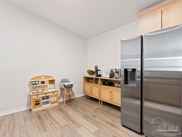 kitchen featuring light brown cabinets, stainless steel refrigerator with ice dispenser, and light hardwood / wood-style floors