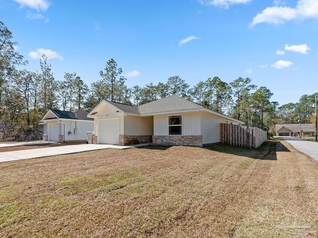 ranch-style house with a garage and a front lawn