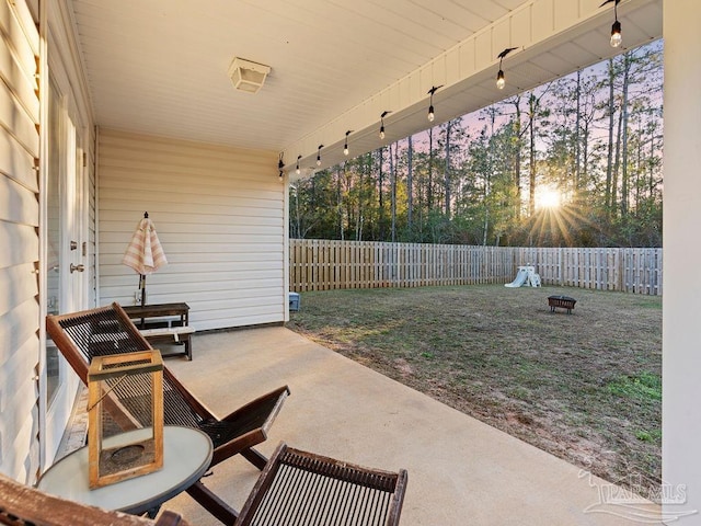 patio terrace at dusk featuring an outdoor fire pit