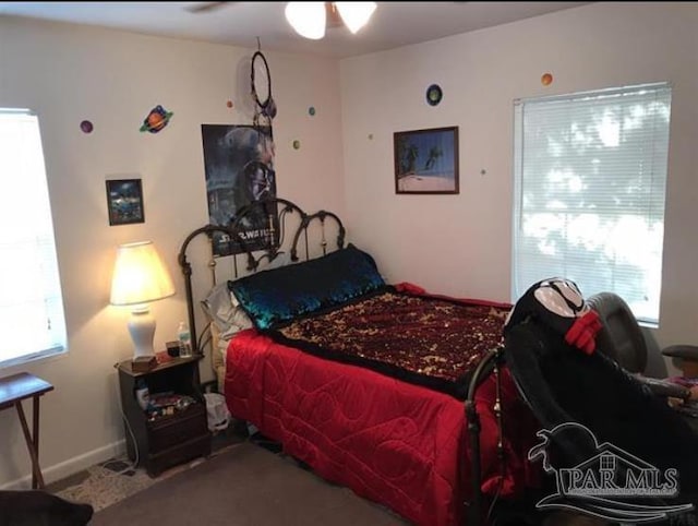 bedroom with multiple windows and ceiling fan