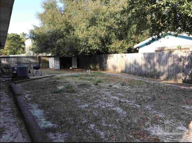 1790 Abercrombie Rd, Gulf Breeze, FL 32563 - fenced backyard with a storage unit, an outdoor structure, and central AC