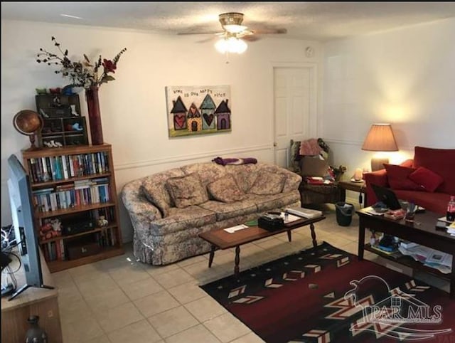 tiled living room with ceiling fan