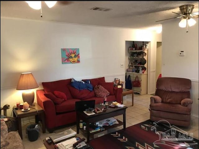 living room with light tile patterned floors and ceiling fan