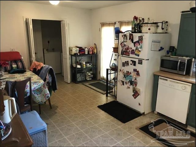 1790 Abercrombie Rd, Gulf Breeze, FL 32563 - kitchen featuring white appliances, washer / clothes dryer, light countertops, and light floors
