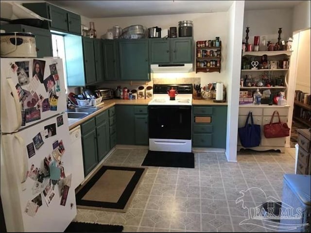 1790 Abercrombie Rd, Gulf Breeze, FL 32563 - kitchen with freestanding refrigerator, electric range oven, green cabinetry, light countertops, and extractor fan