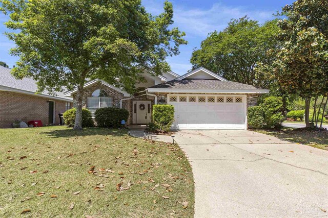 ranch-style house featuring a garage and a front yard