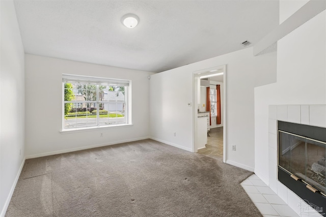 unfurnished living room featuring light colored carpet and a fireplace