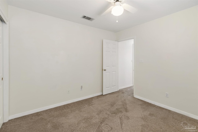 unfurnished bedroom with light carpet and ceiling fan