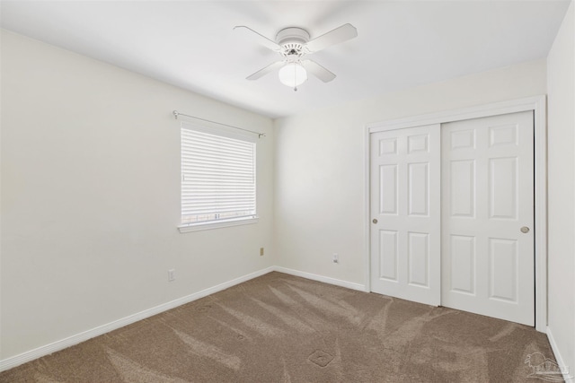 unfurnished bedroom featuring carpet floors, a closet, and ceiling fan