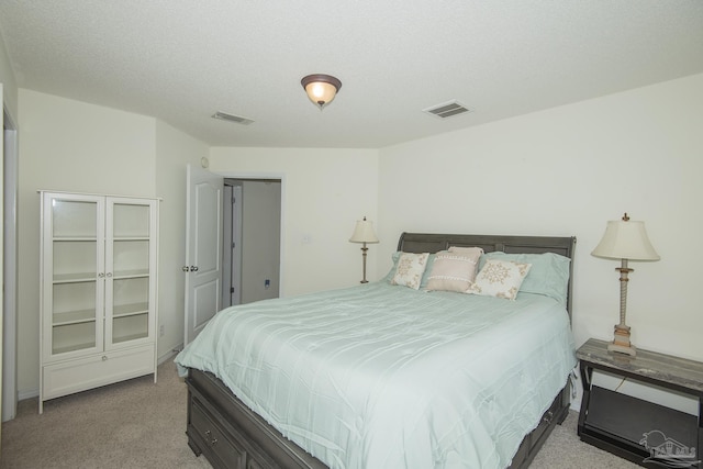 carpeted bedroom featuring visible vents