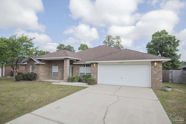 ranch-style home with brick siding, an attached garage, a front yard, and concrete driveway