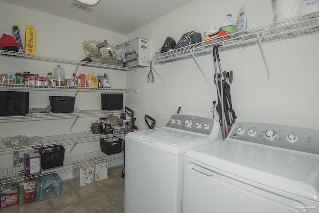 clothes washing area with laundry area and washer and clothes dryer
