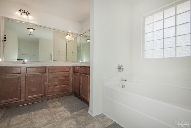 full bath featuring double vanity and a bath
